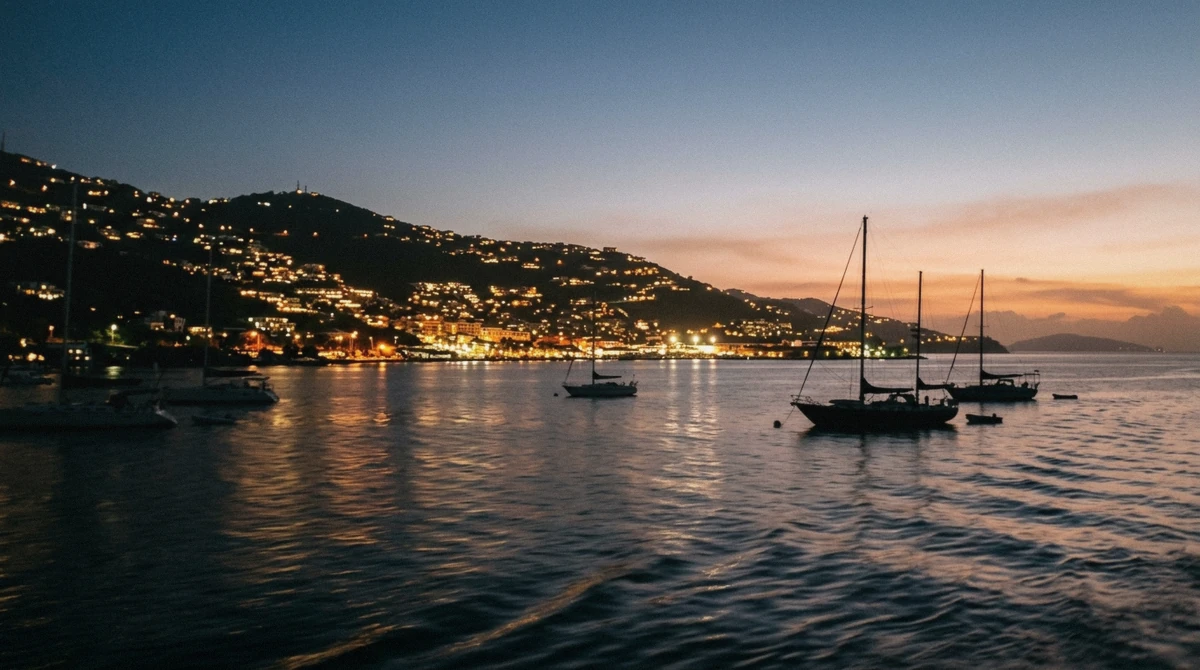 The lights of Charlotte Amalie harbor glowing at dusk seen from the water at the end of a sunset cruise in St. Thomas USVI